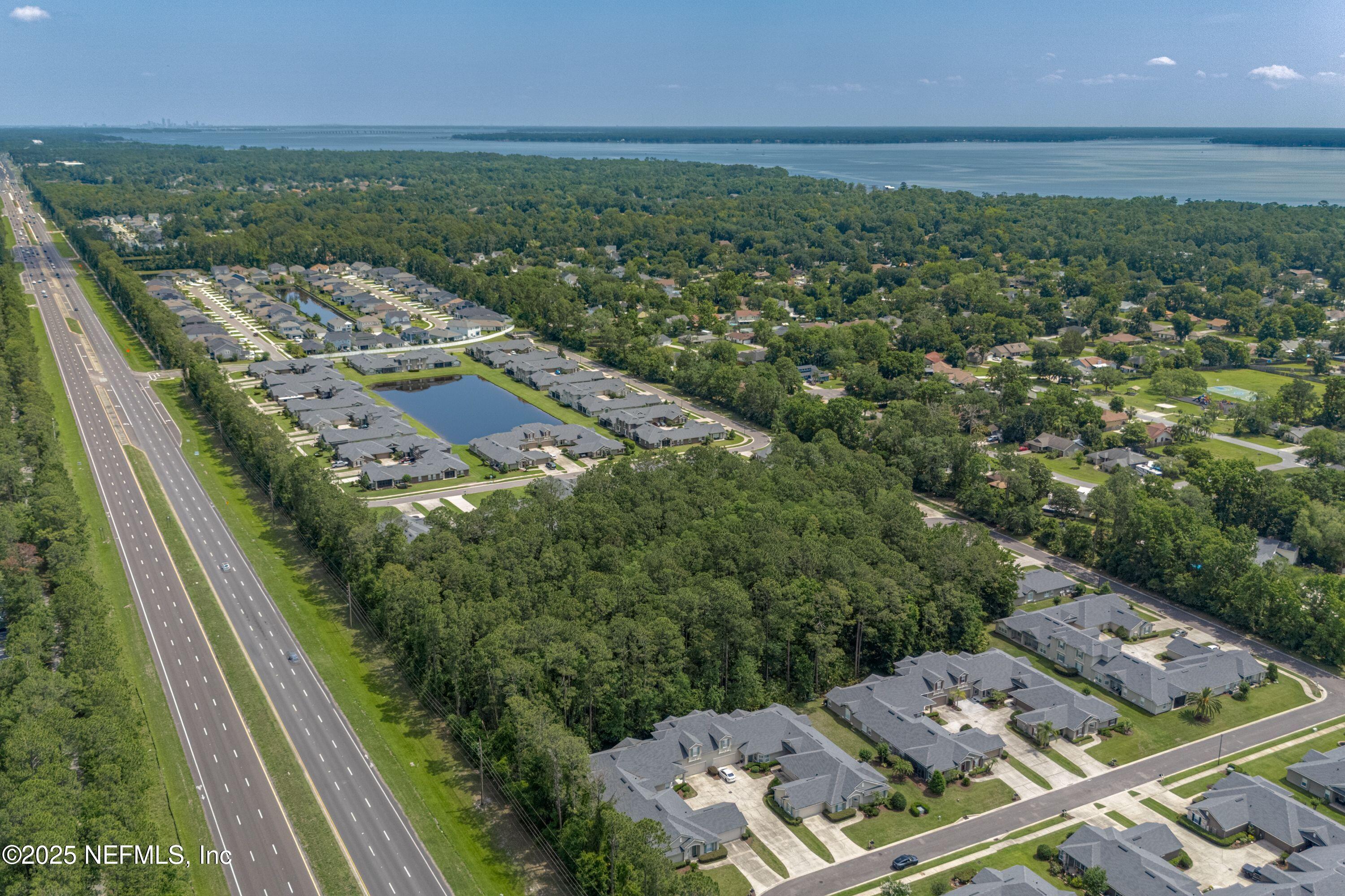 2120 Stone Creek Drive, Unit E Fleming Island, FL 32003 - Photo 37 of 66 an aerial view of a residential houses with outdoor space and trees