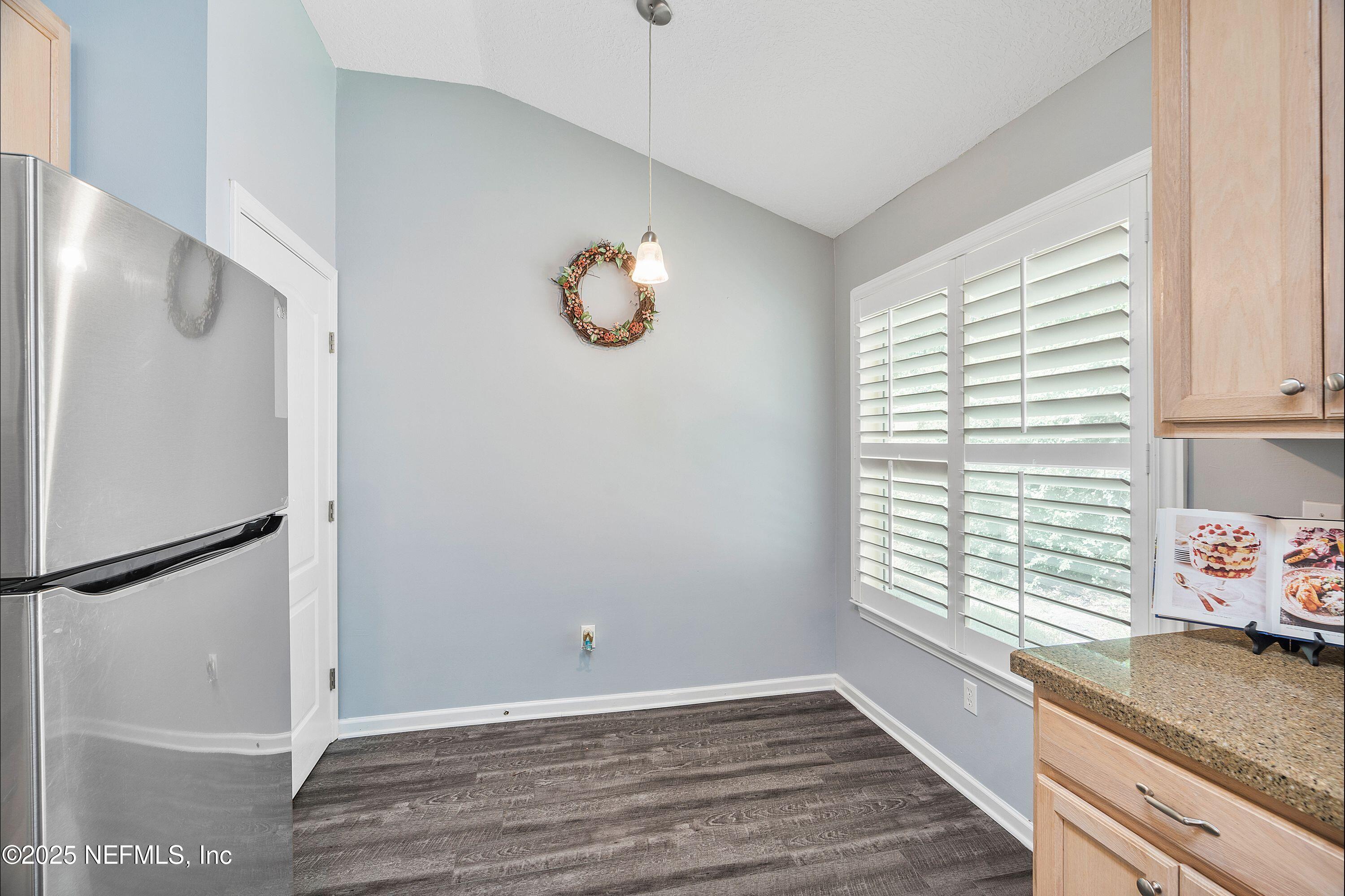 2120 Stone Creek Drive, Unit E Fleming Island, FL 32003 - Photo 5 of 66 a view of a kitchen with a window and a refrigerator