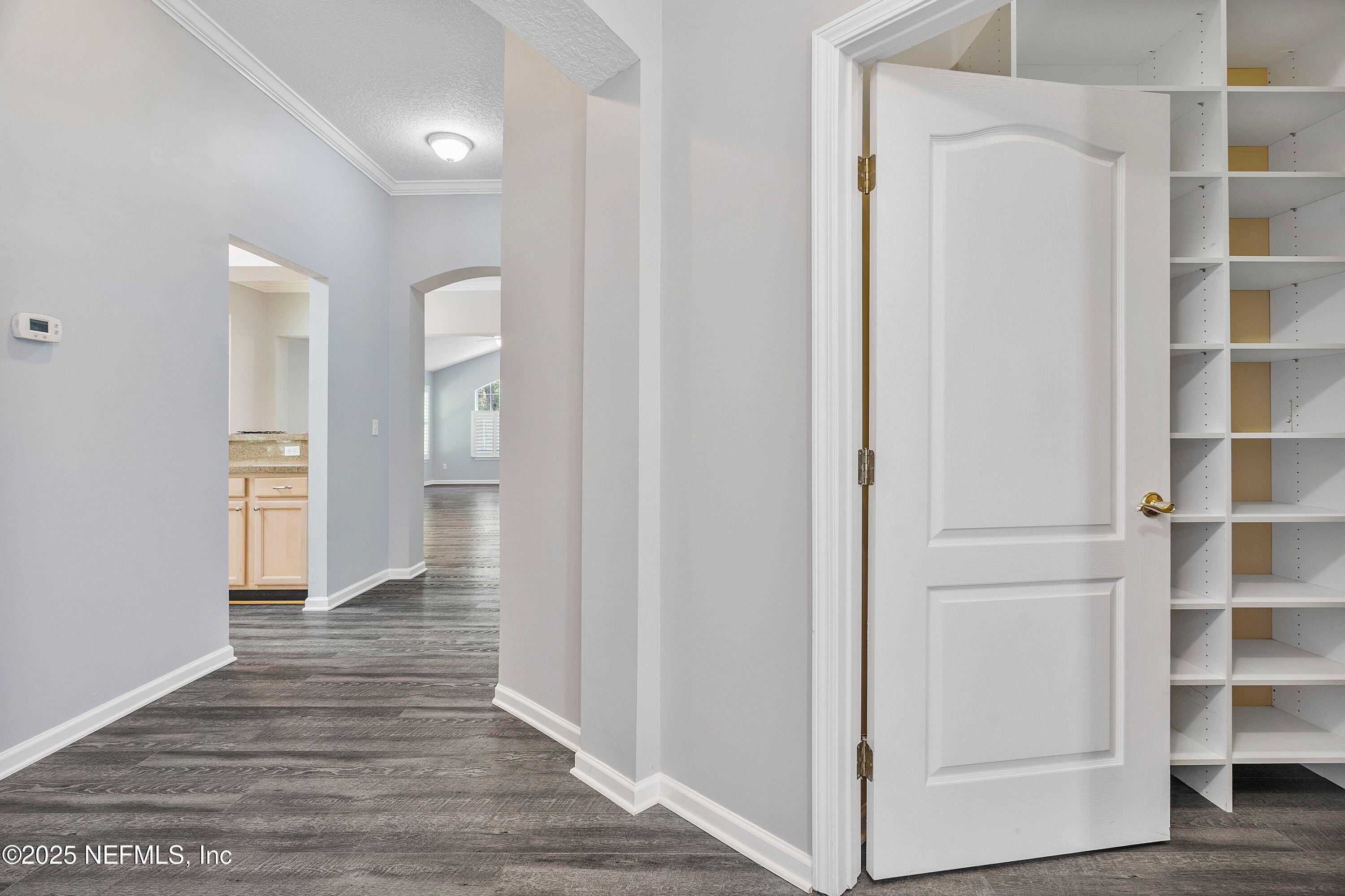 2120 Stone Creek Drive, Unit E Fleming Island, FL 32003 - Photo 7 of 66 a view of walk in closet with empty racks