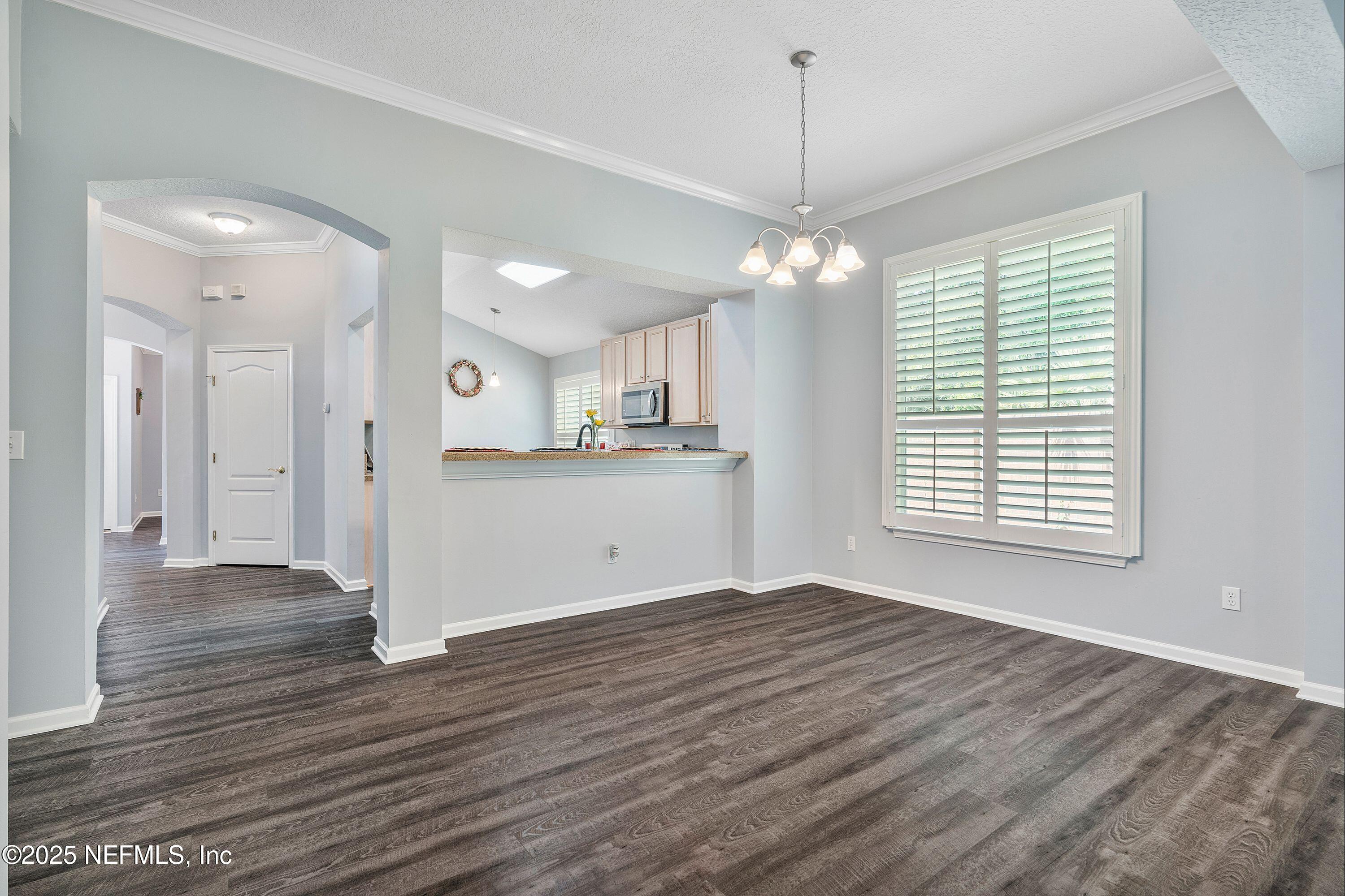 2120 Stone Creek Drive, Unit E Fleming Island, FL 32003 - Photo 10 of 66 a view of a kitchen with a dishwasher cabinets and a window