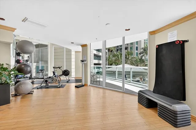 a living room with furniture ceiling fan and a wooden floor