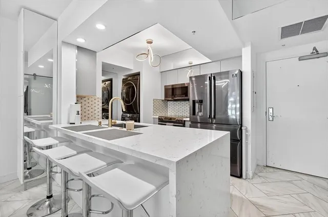a view of kitchen island a sink and living room