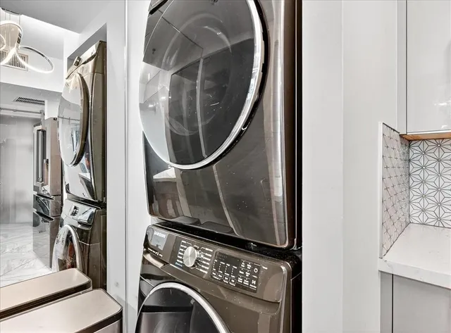 a view of kitchen with kitchen island stainless steel appliances refrigerator stove dining table and chairs