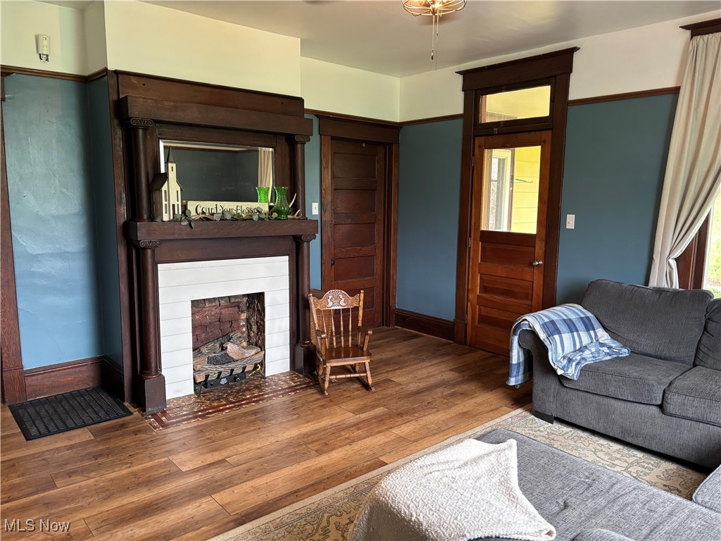 6380 Old River Road Philo, OH 43771 - Photo 8 of 26 Living area with a fireplace with flush hearth, baseboards, and wood finished floors