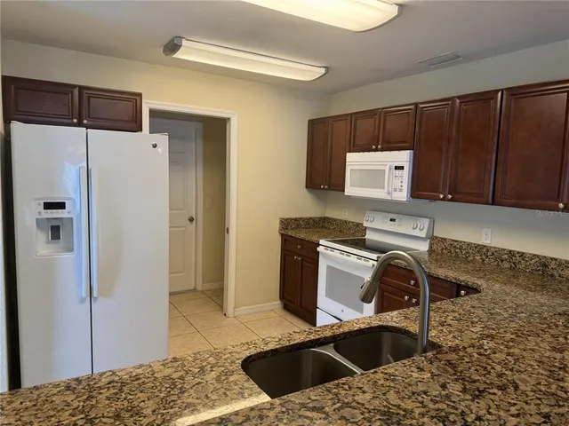 a kitchen with a refrigerator sink and stove