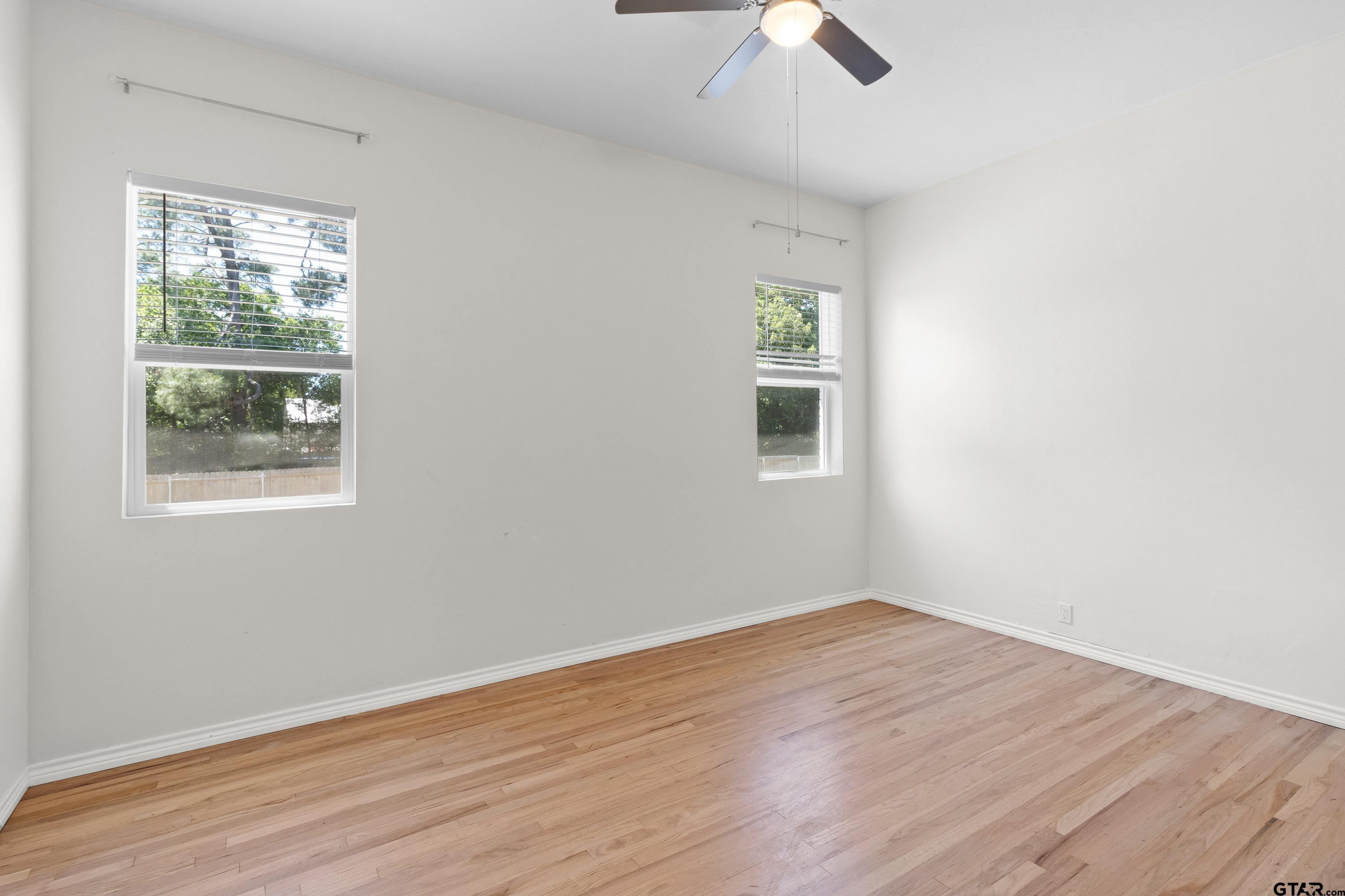 4456 Farm To Market Road 2767 Tyler, TX 75708 - Photo 16 of 46 an empty room with a window and wooden floor