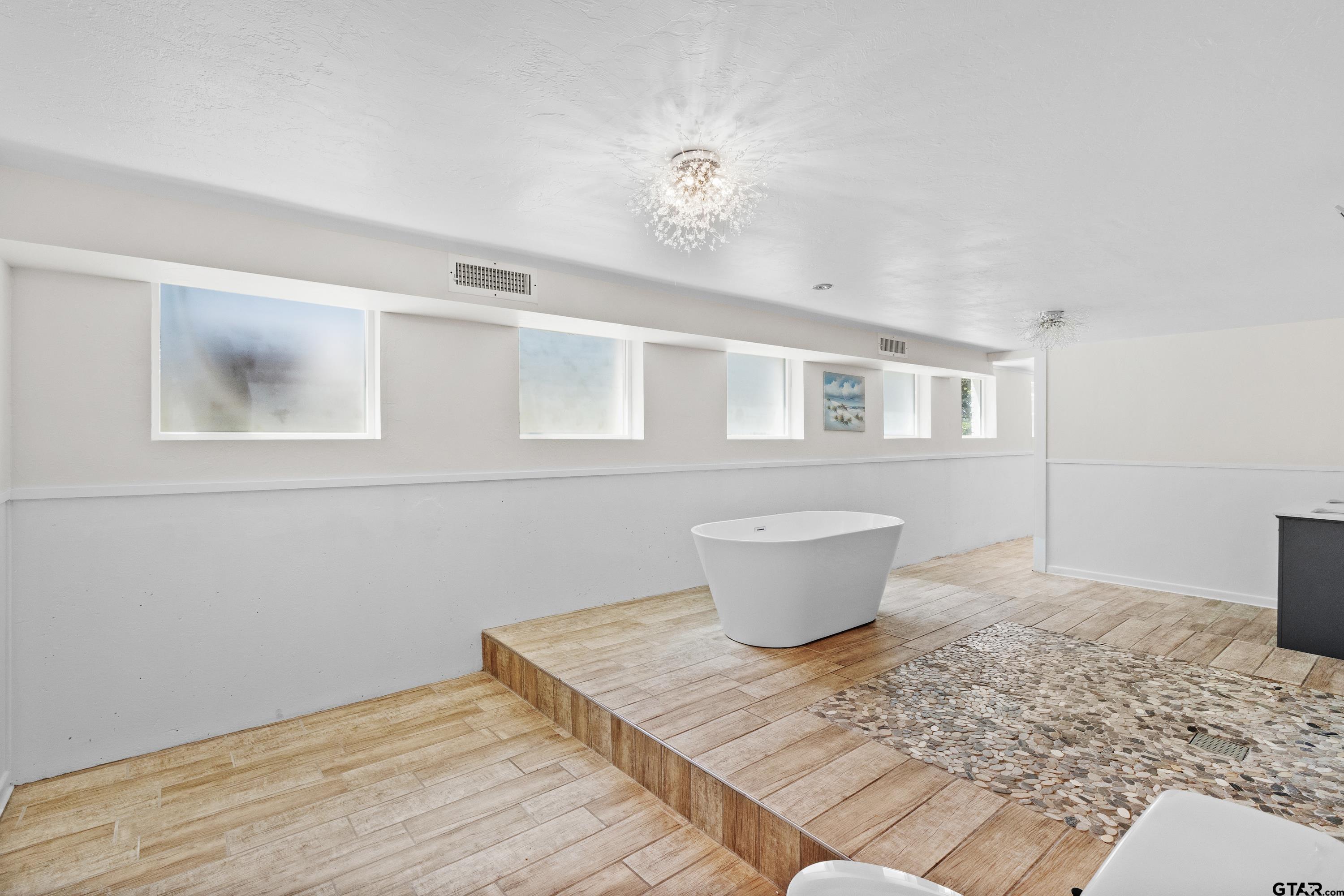 4456 Farm To Market Road 2767 Tyler, TX 75708 - Photo 30 of 46 a view of a room with wooden floor and chandelier