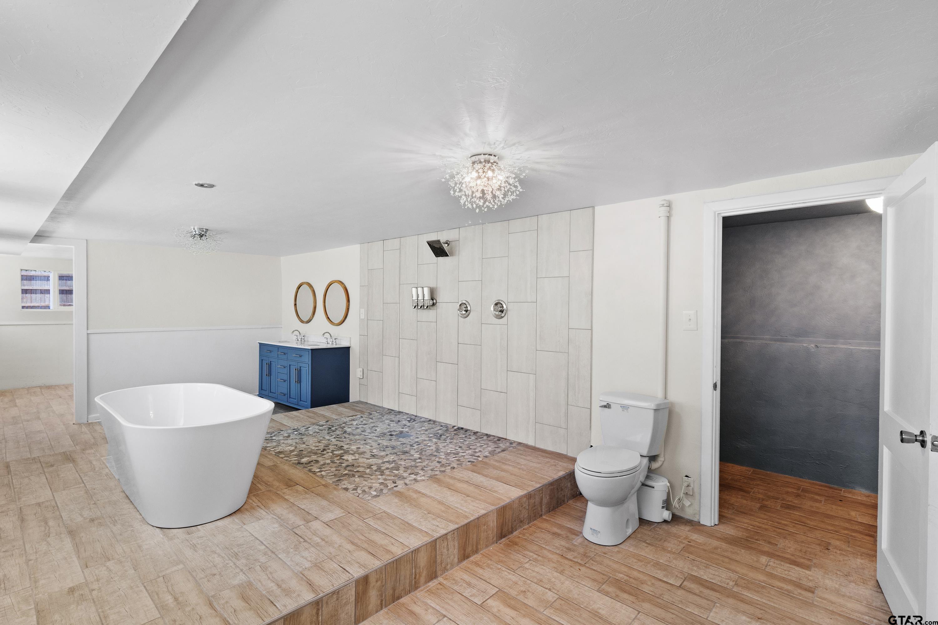 4456 Farm To Market Road 2767 Tyler, TX 75708 - Photo 31 of 46 a view of a room with wooden floor and bathroom