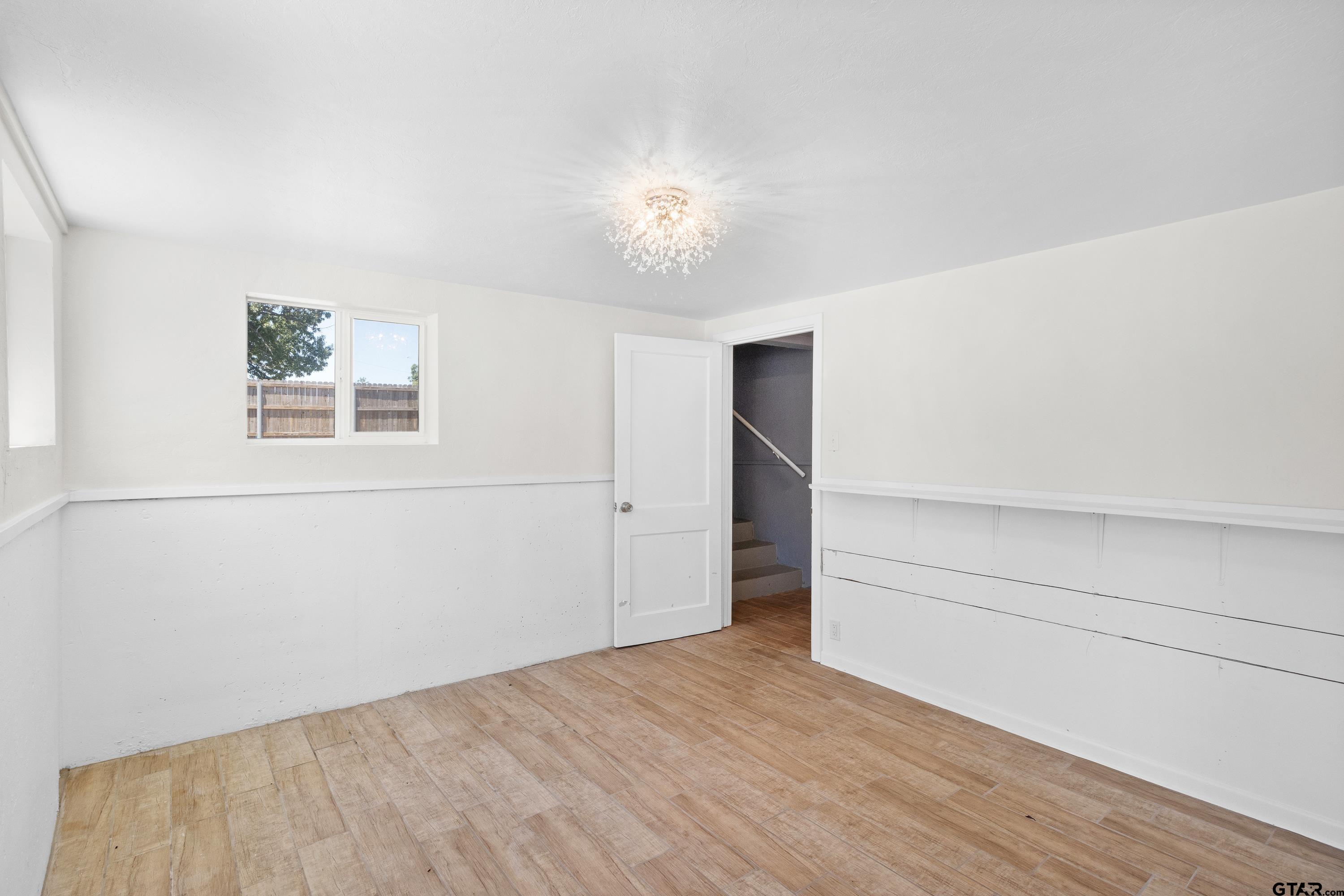 4456 Farm To Market Road 2767 Tyler, TX 75708 - Photo 33 of 46 a view of empty room with wooden floor and fan