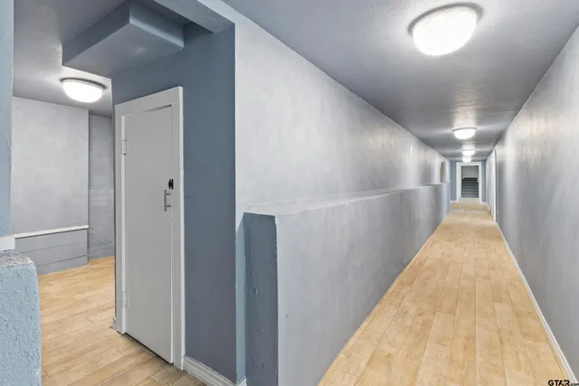 a view of gallery with wooden floor