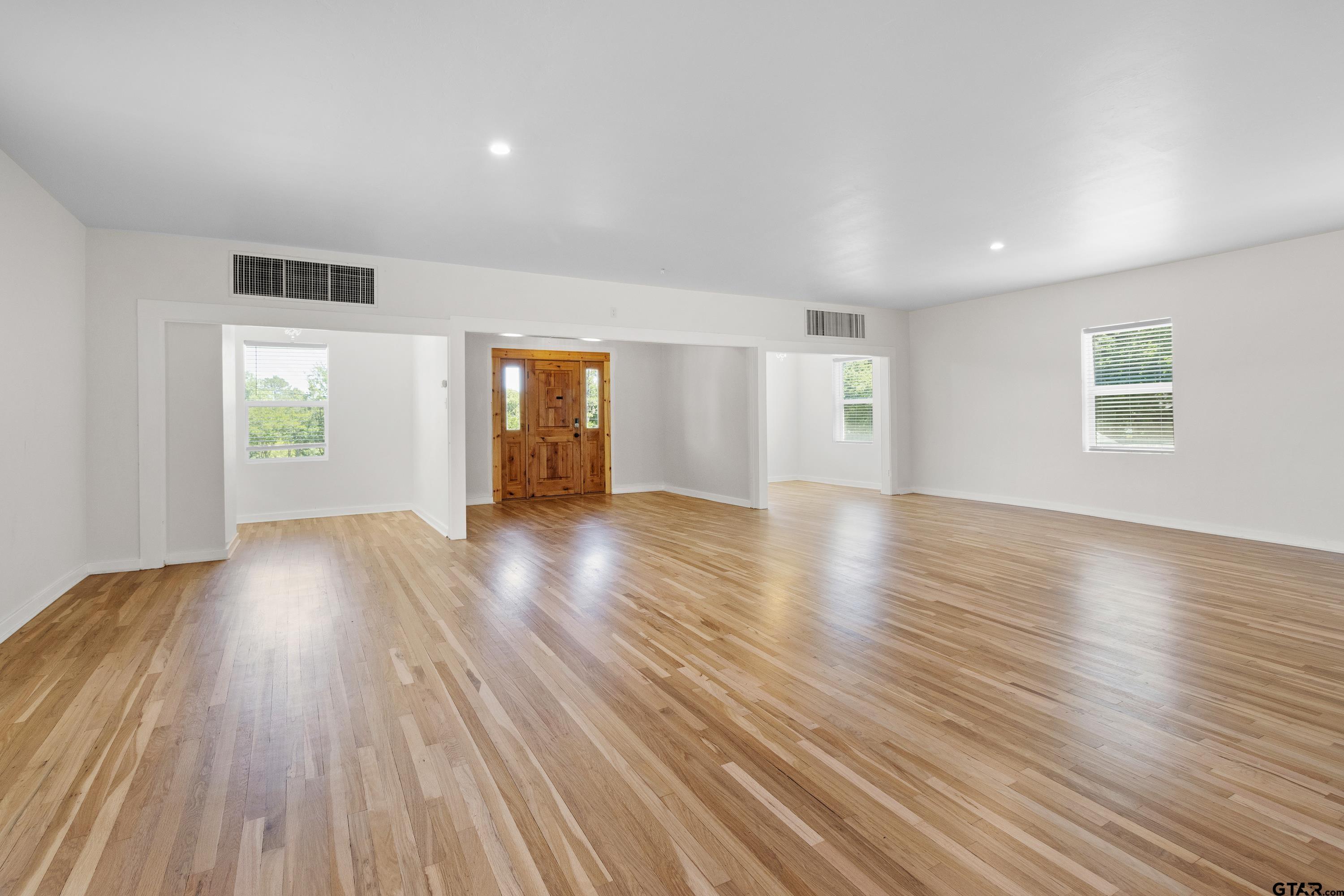 4456 Farm To Market Road 2767 Tyler, TX 75708 - Photo 39 of 46 an empty room with wooden floor and windows