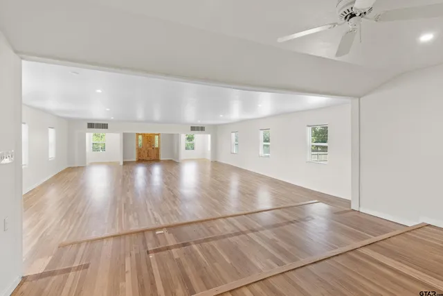 a view of a hallway with wooden floor