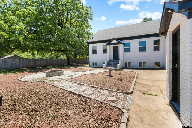 a view of a backyard with a tree
