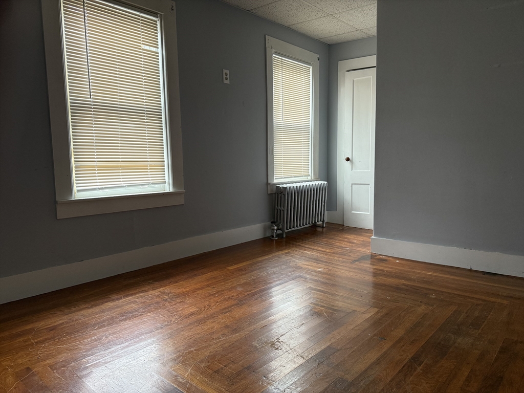 114 North Street Ware, MA 01082 - Photo 11 of 25 a view of an empty room with wooden floor and a window