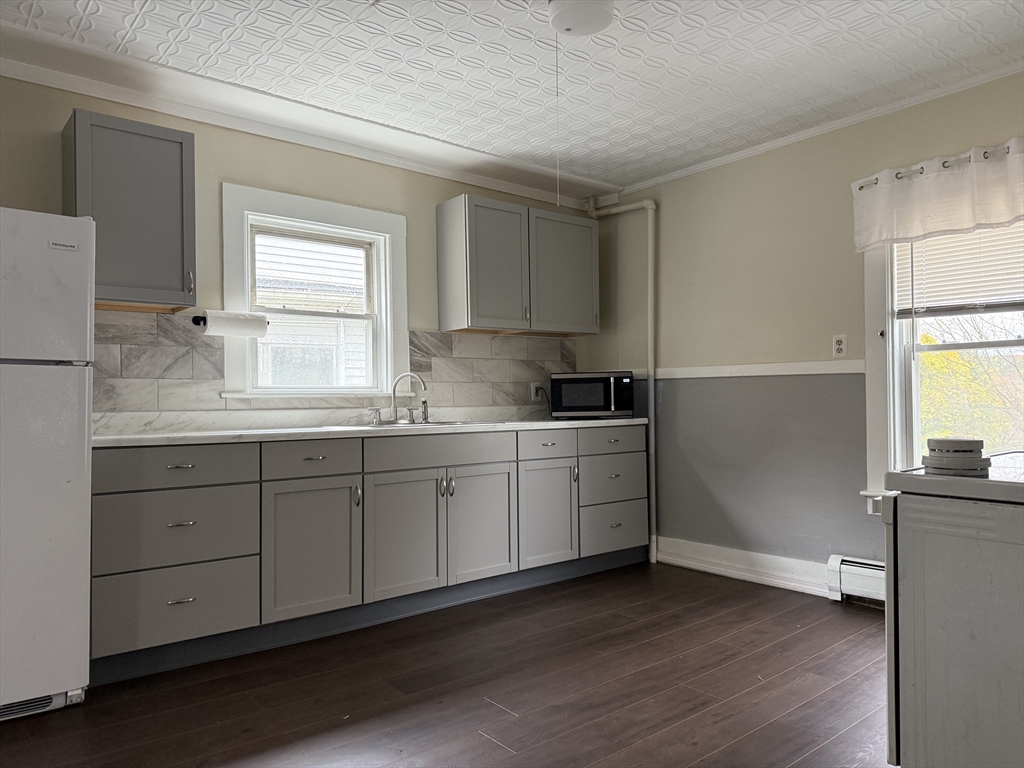 114 North Street Ware, MA 01082 - Photo 15 of 25 a kitchen with granite countertop white cabinets and white appliances