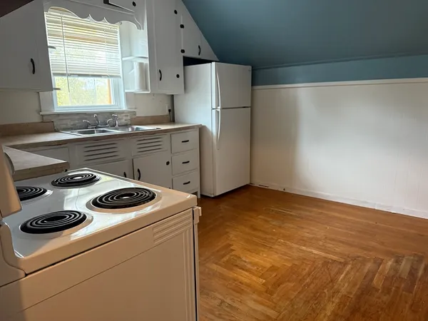 a kitchen with a stove a refrigerator and a stove