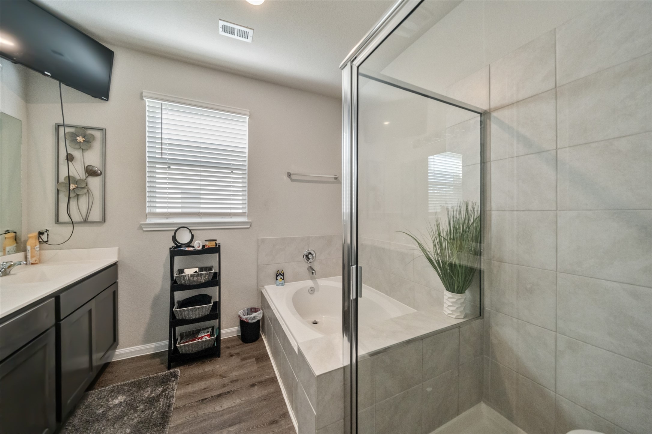 2302 Raider Drive Conroe, TX 77301 - Photo 11 of 25 a bathroom with a tub a sink and a large mirror