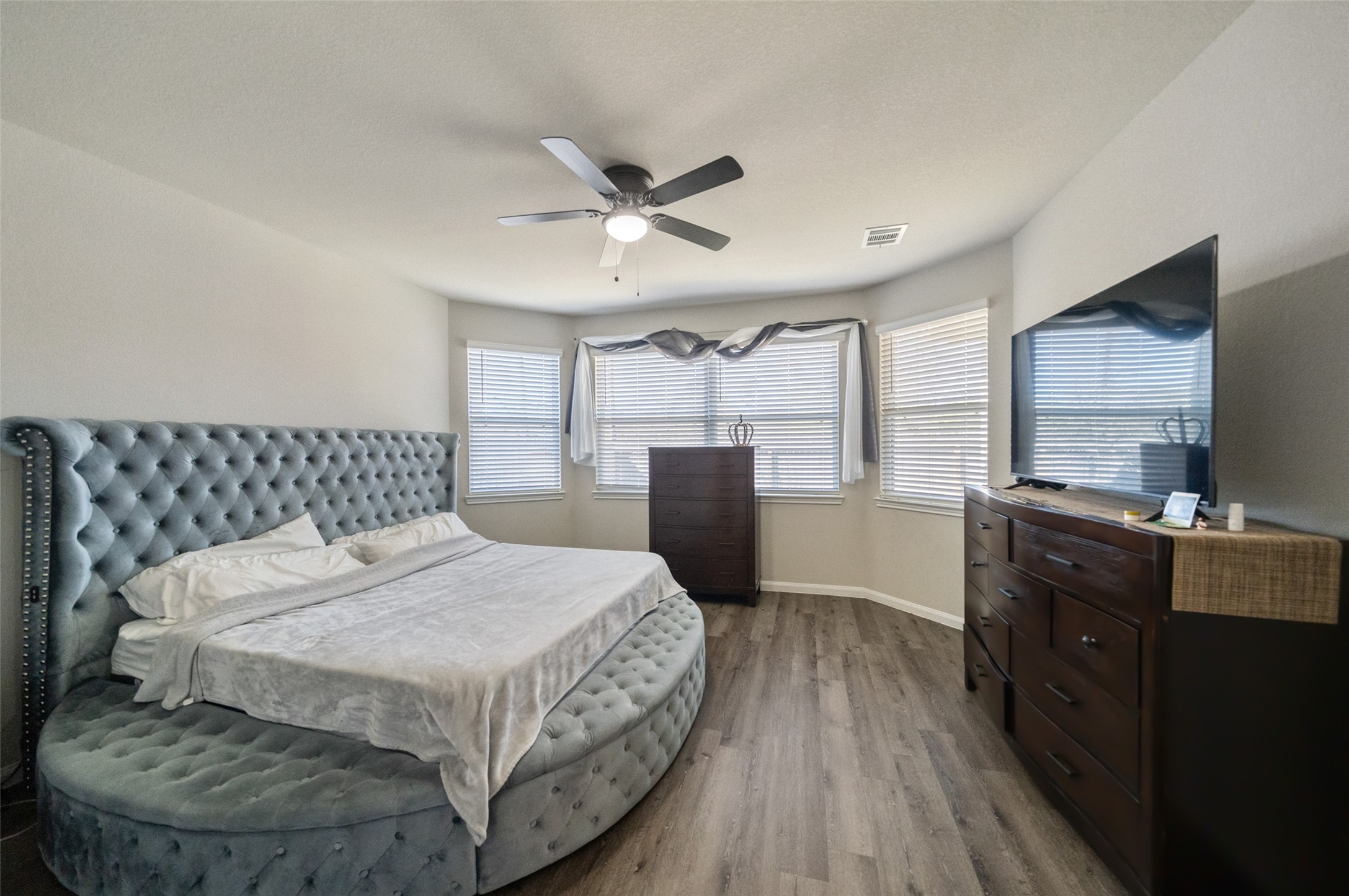 2302 Raider Drive Conroe, TX 77301 - Photo 12 of 25 a bedroom with a bed and wooden floor