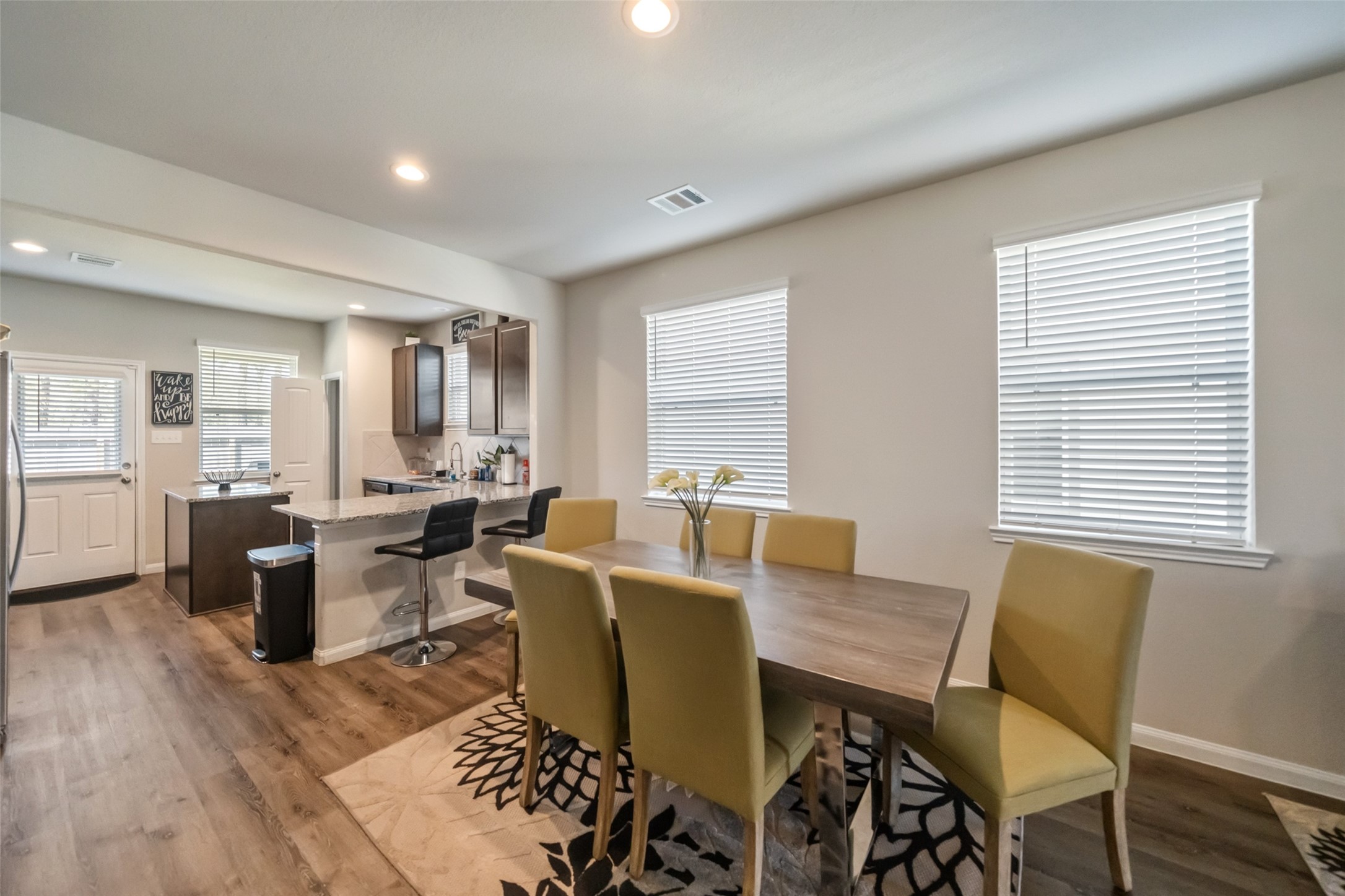 2302 Raider Drive Conroe, TX 77301 - Photo 17 of 25 a view of a dining room with furniture and wooden floor