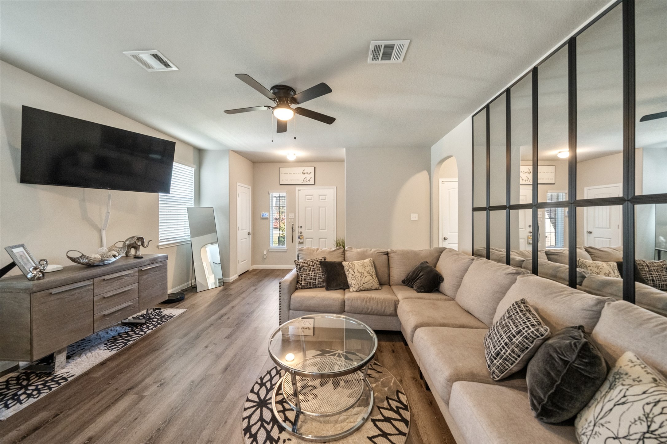 2302 Raider Drive Conroe, TX 77301 - Photo 18 of 25 a living room with furniture a flat screen tv and a floor to ceiling window