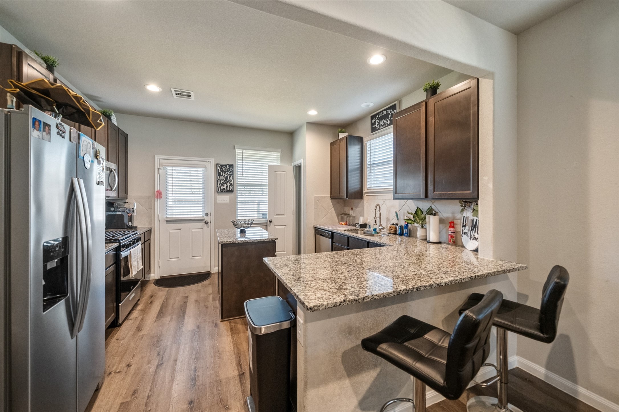 2302 Raider Drive Conroe, TX 77301 - Photo 19 of 25 a kitchen with refrigerator and chairs