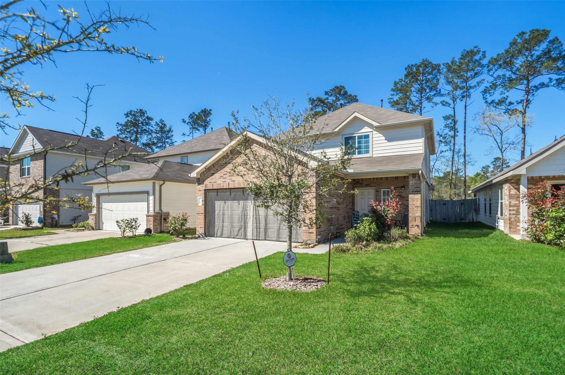 2302 Raider Drive Conroe, TX 77301 - Photo 2 of 25 a front view of a house with a yard and garage