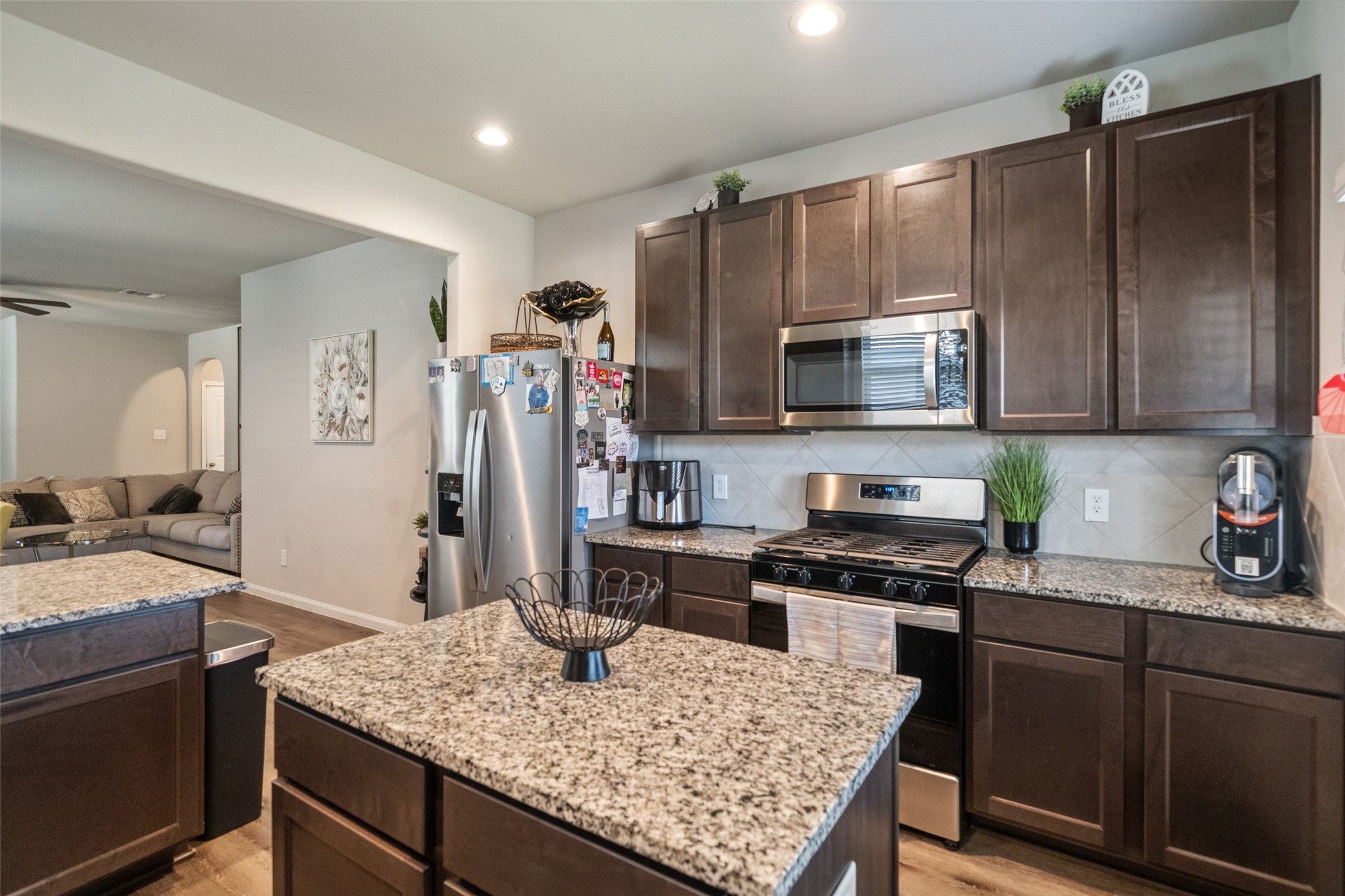 2302 Raider Drive Conroe, TX 77301 - Photo 21 of 25 a kitchen with kitchen island granite countertop a sink stove and refrigerator