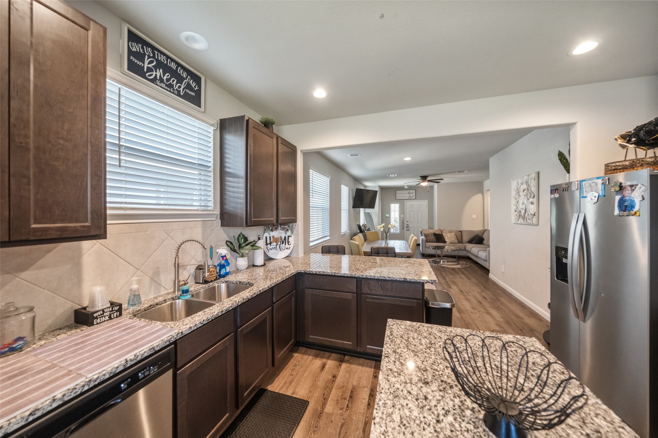 2302 Raider Drive Conroe, TX 77301 - Photo 22 of 25 a kitchen with granite countertop a sink stove and refrigerator