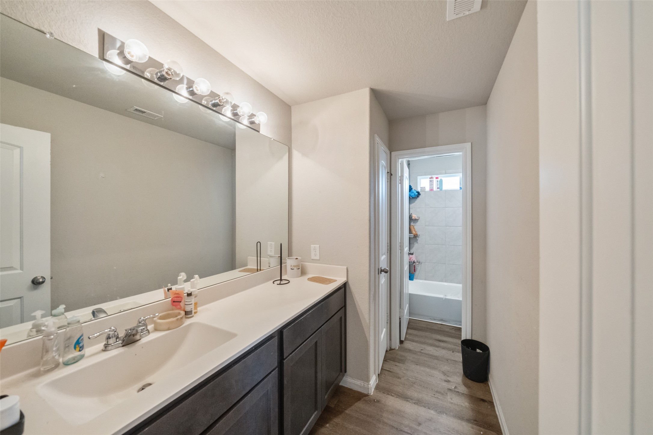 2302 Raider Drive Conroe, TX 77301 - Photo 6 of 25 a en suite bathroom with a double vanity sink and mirror