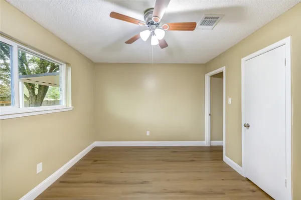 a view of room with window and ceiling fan