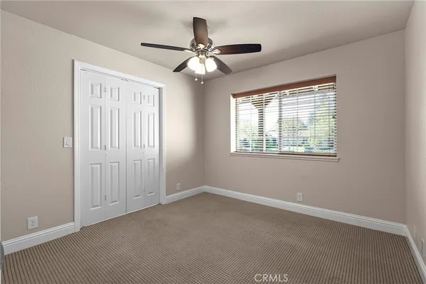 a view of a hallway with wooden floor and closet