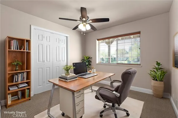 a kitchen with granite countertop white cabinets and a window
