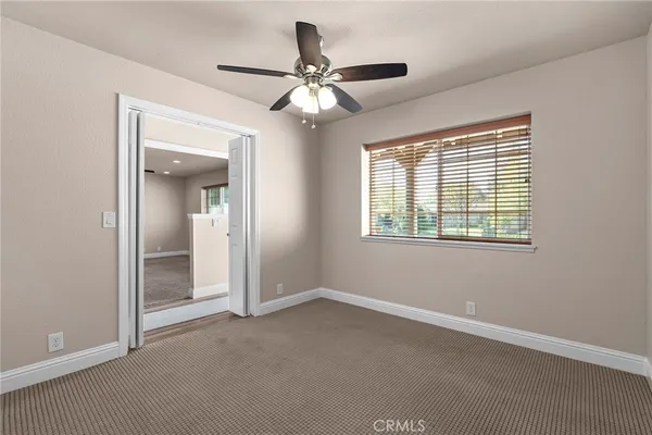 a kitchen with stainless steel appliances a refrigerator a sink a stove a table and chairs