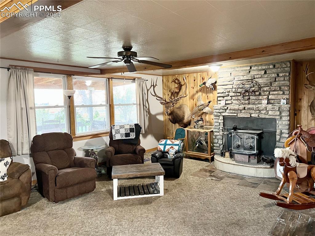 34650 Bellemont Road Yoder, CO 80864 - Photo 20 of 29 a living room with furniture a fireplace and a floor to ceiling window