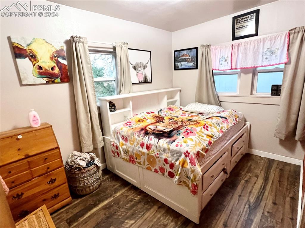 34650 Bellemont Road Yoder, CO 80864 - Photo 25 of 29 a bedroom with a bed and wooden floor