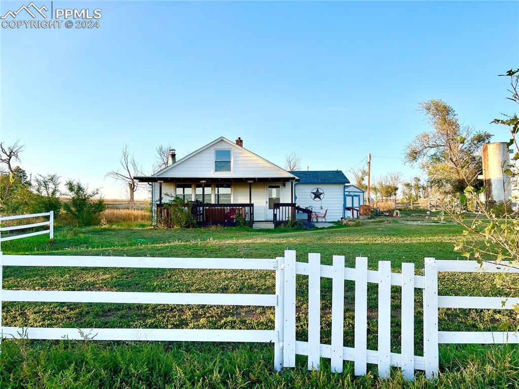 34650 Bellemont Road Yoder, CO 80864 - Photo 5 of 29 a front view of a house with a yard table and chairs