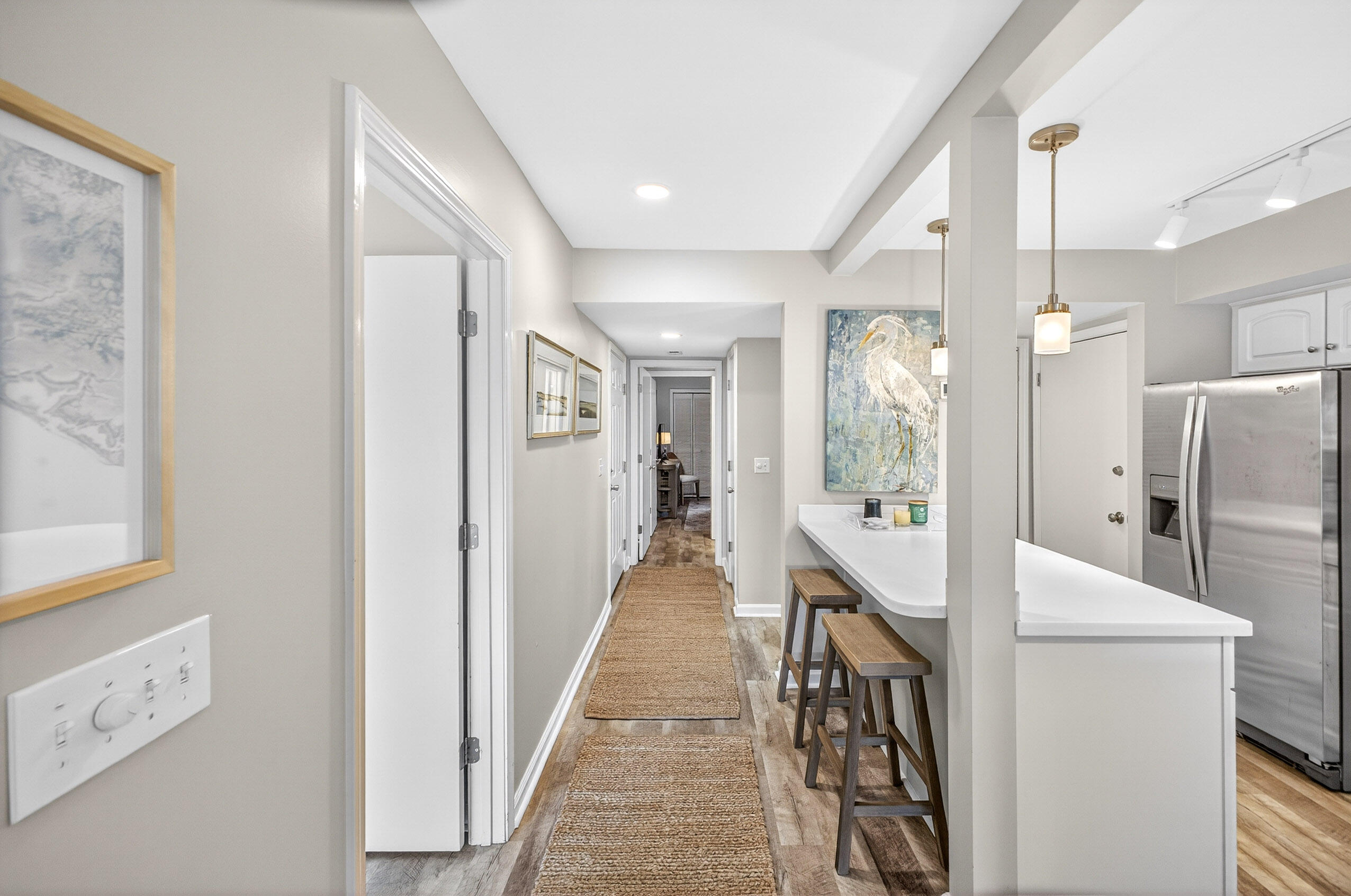 900 Harbour Point Lane, Unit 900 Miramar Beach, FL 32550 - Photo 11 of 64 a view of a hallway with dining room and wooden floor