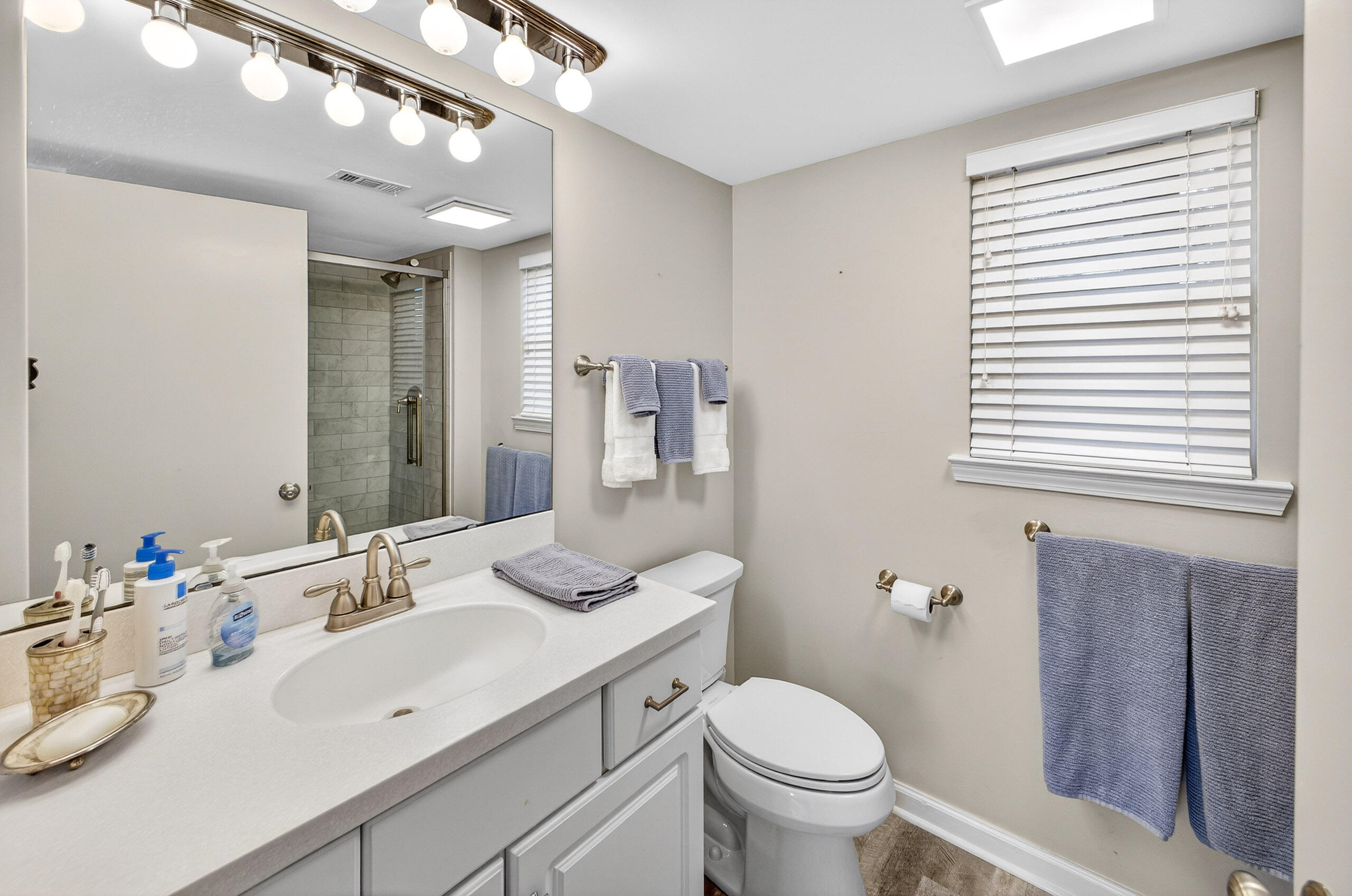 900 Harbour Point Lane, Unit 900 Miramar Beach, FL 32550 - Photo 22 of 64 a bathroom with a toilet sink and mirror