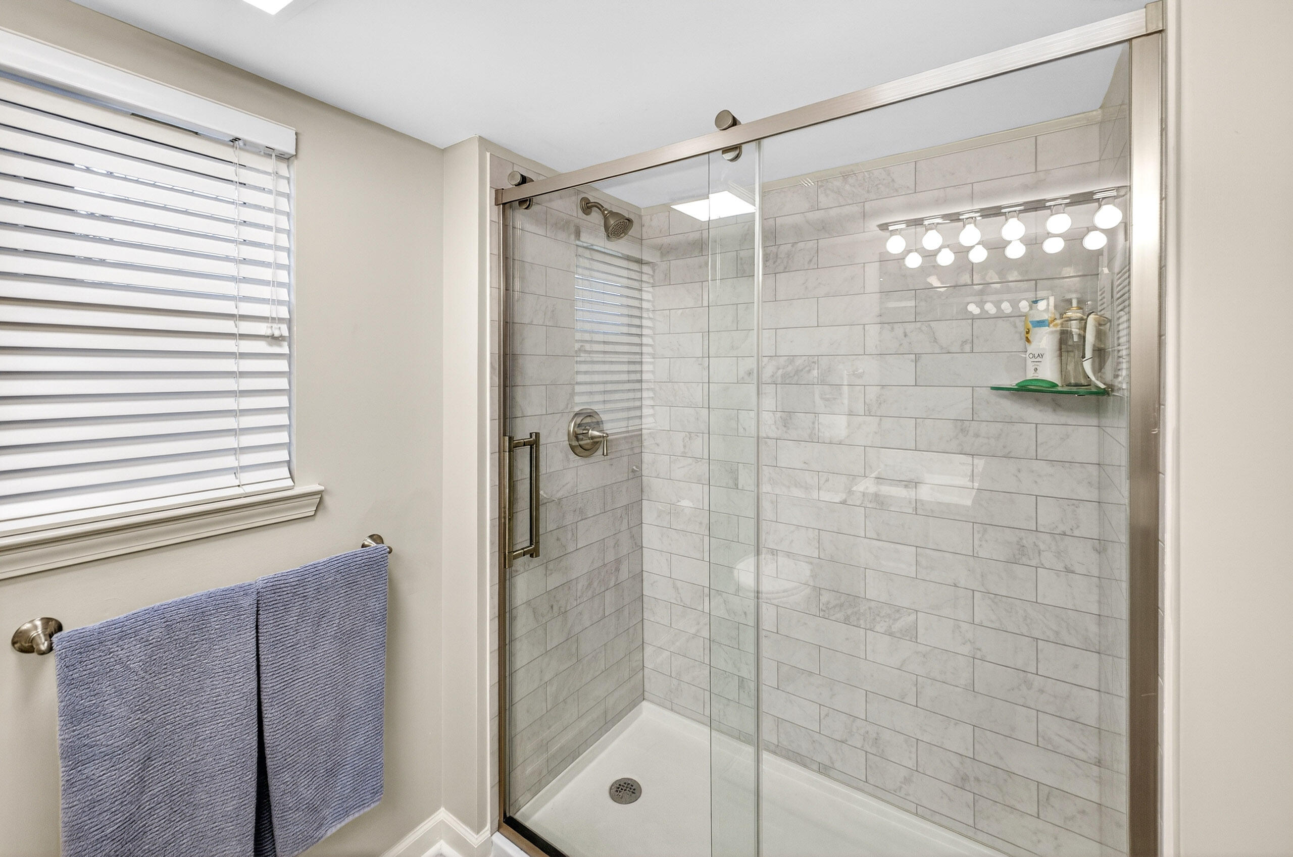 900 Harbour Point Lane, Unit 900 Miramar Beach, FL 32550 - Photo 23 of 64 a bathroom with a glass shower door