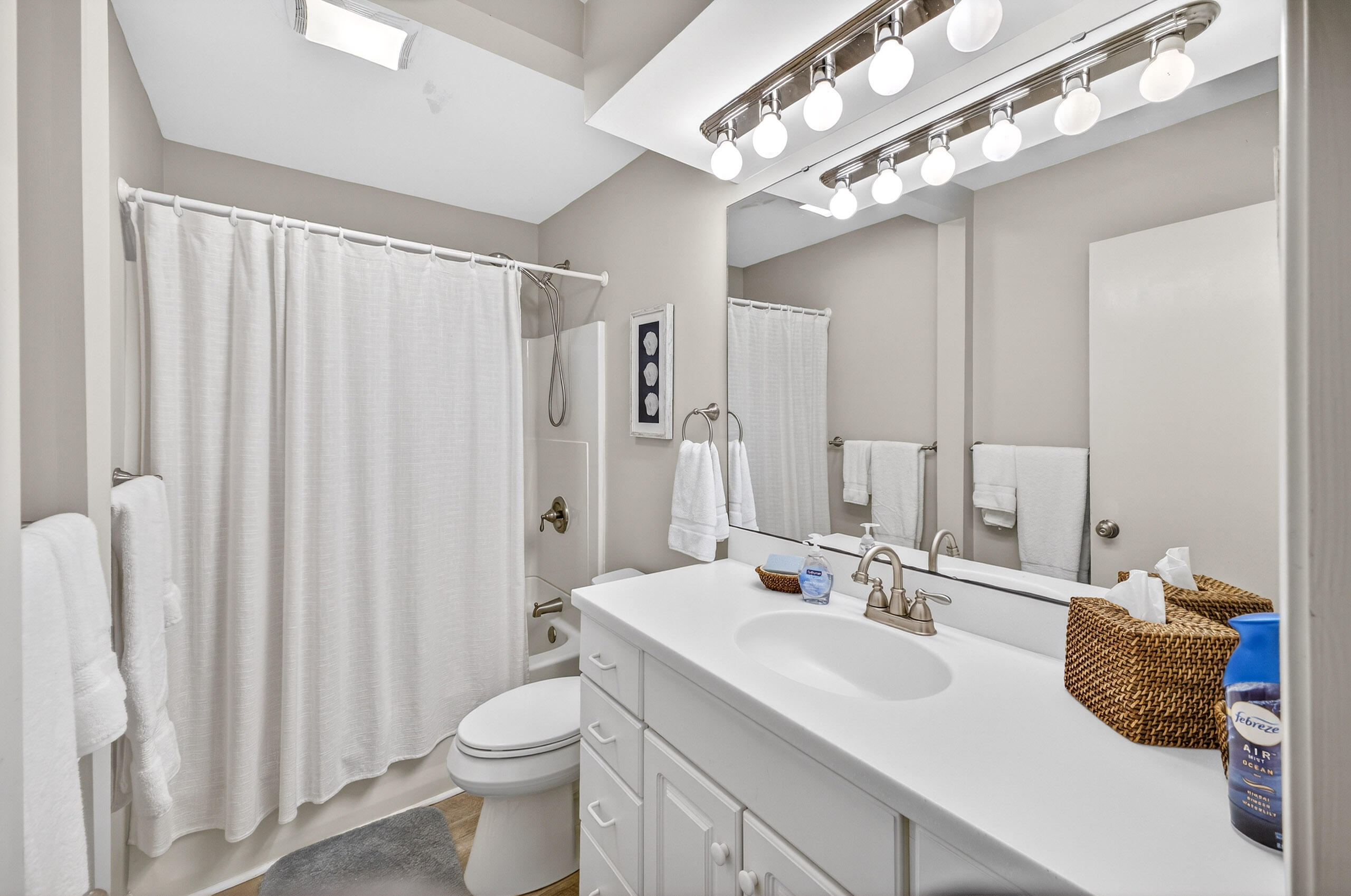 900 Harbour Point Lane, Unit 900 Miramar Beach, FL 32550 - Photo 25 of 64 a bathroom with a double vanity sink toilet and a mirror