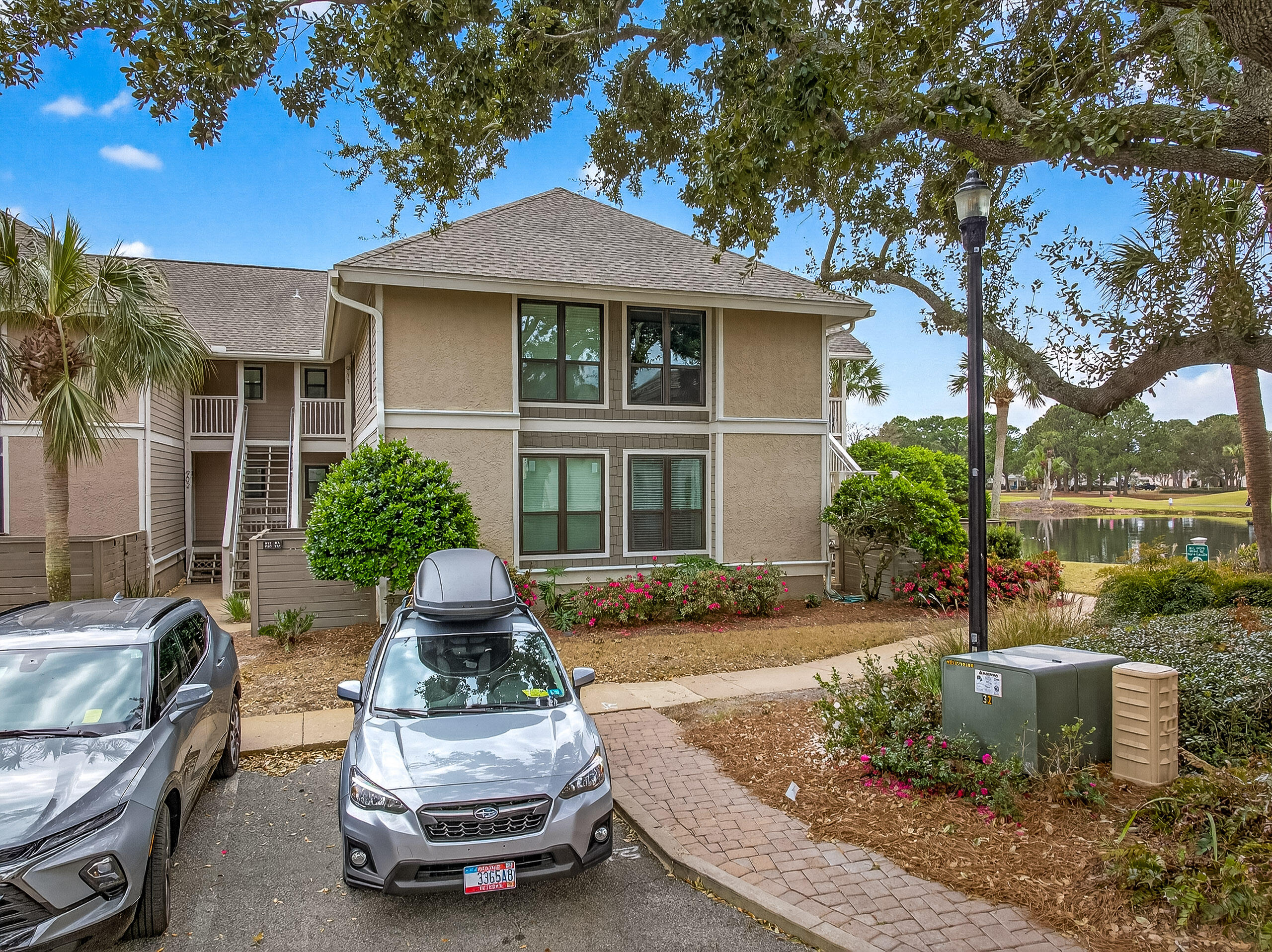 900 Harbour Point Lane, Unit 900 Miramar Beach, FL 32550 - Photo 4 of 64 a front view of a house with a garden and plants