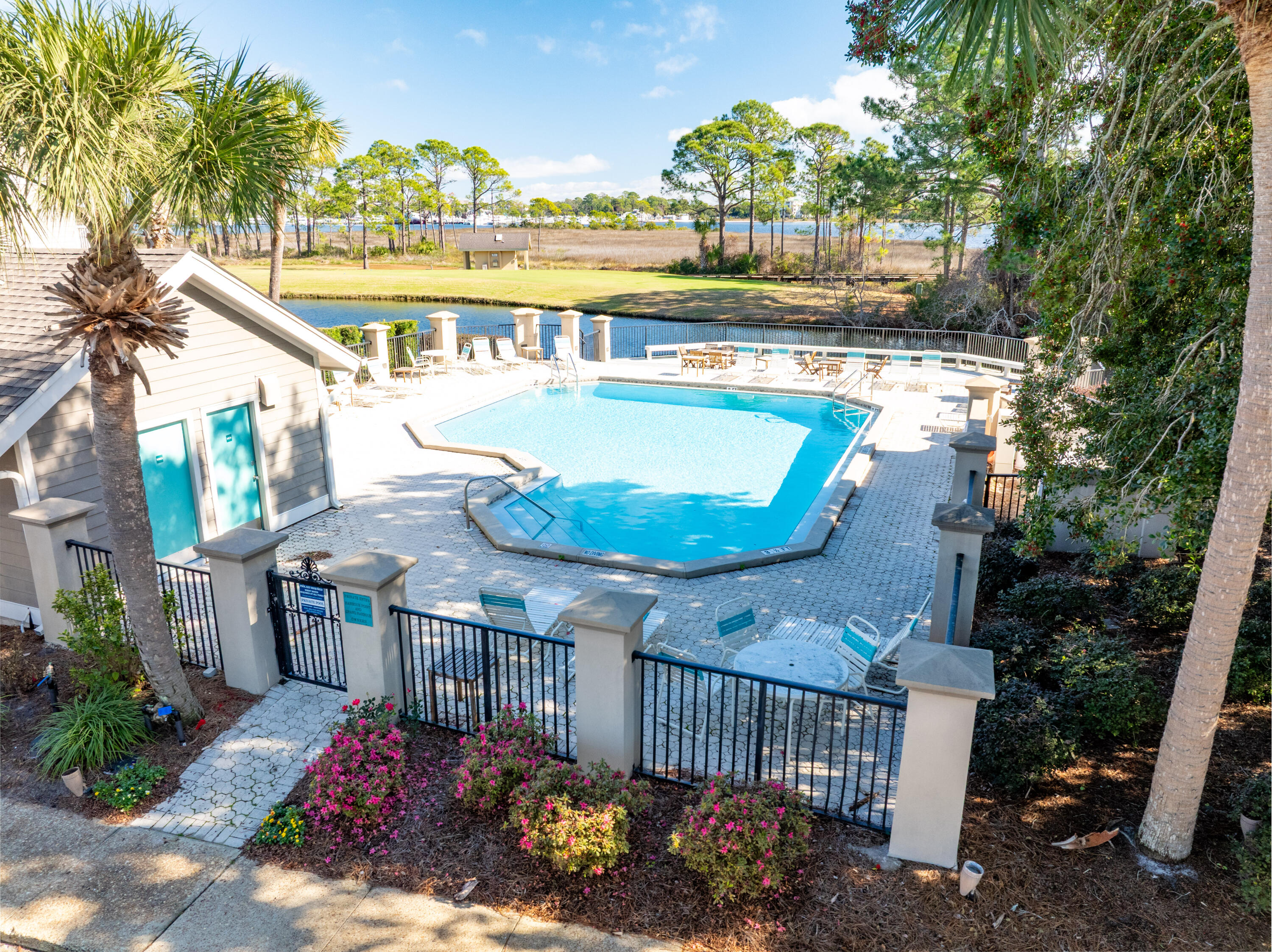 900 Harbour Point Lane, Unit 900 Miramar Beach, FL 32550 - Photo 45 of 64 a view of a swimming pool with a deck and a garden