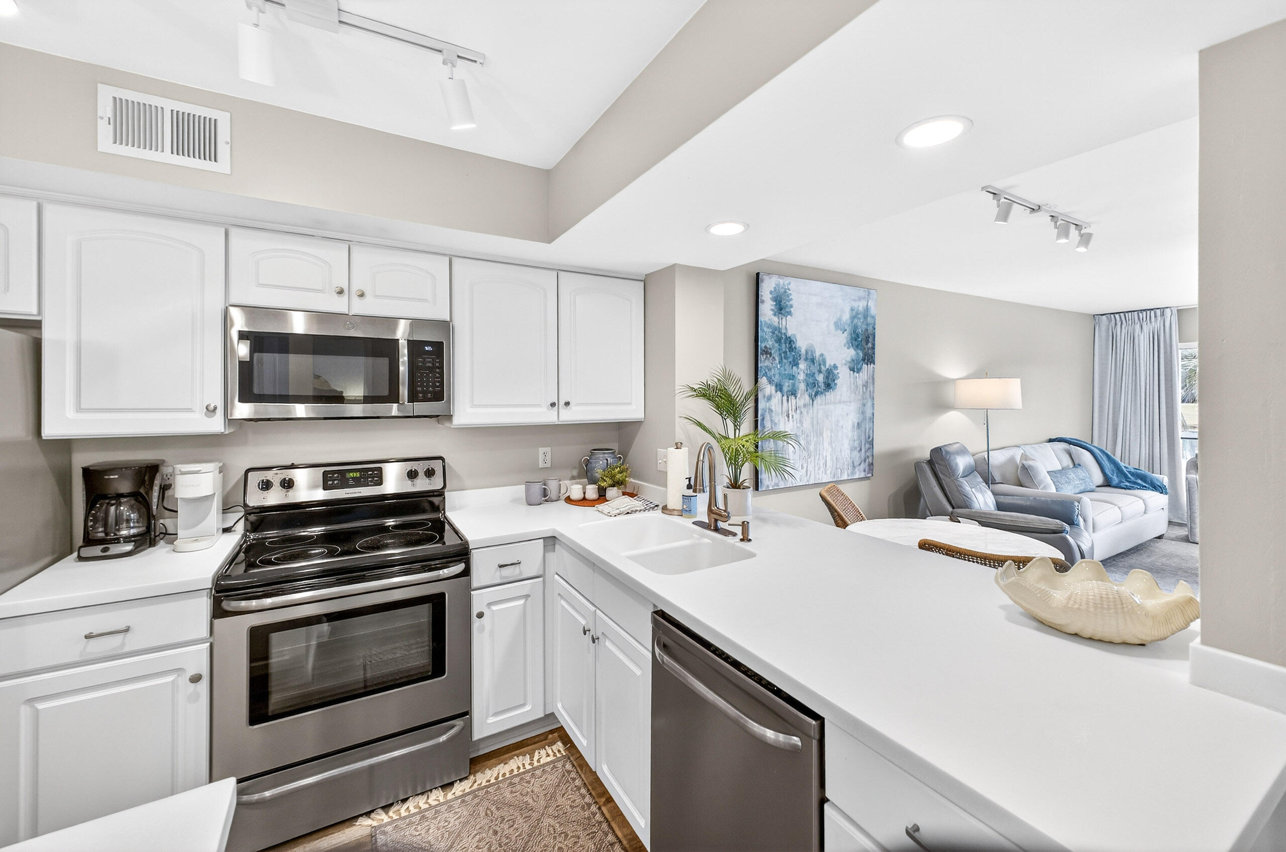 900 Harbour Point Lane, Unit 900 Miramar Beach, FL 32550 - Photo 8 of 64 a kitchen with a sink a stove and microwave