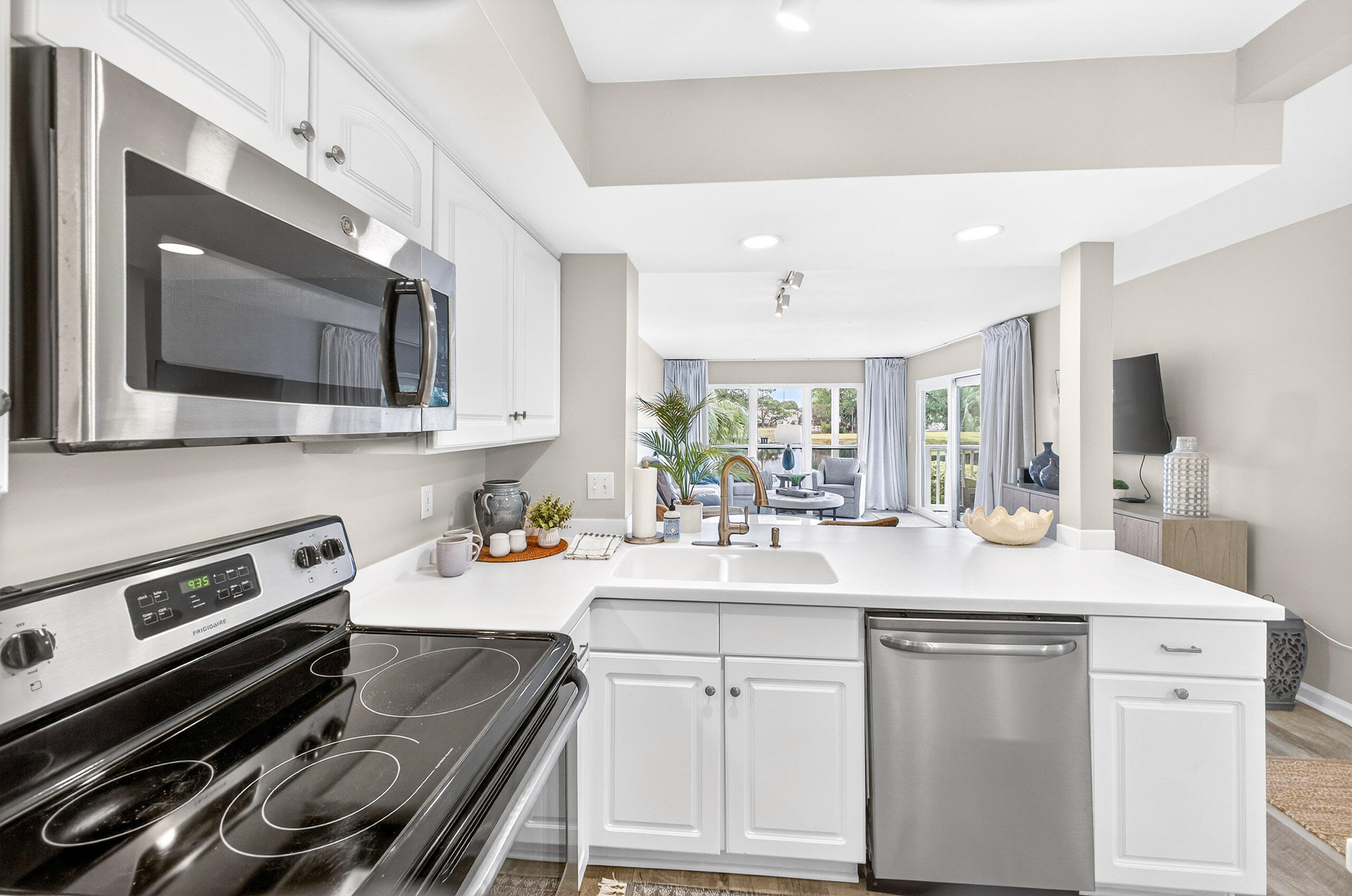 900 Harbour Point Lane, Unit 900 Miramar Beach, FL 32550 - Photo 9 of 64 a kitchen with stainless steel appliances a sink stove and microwave