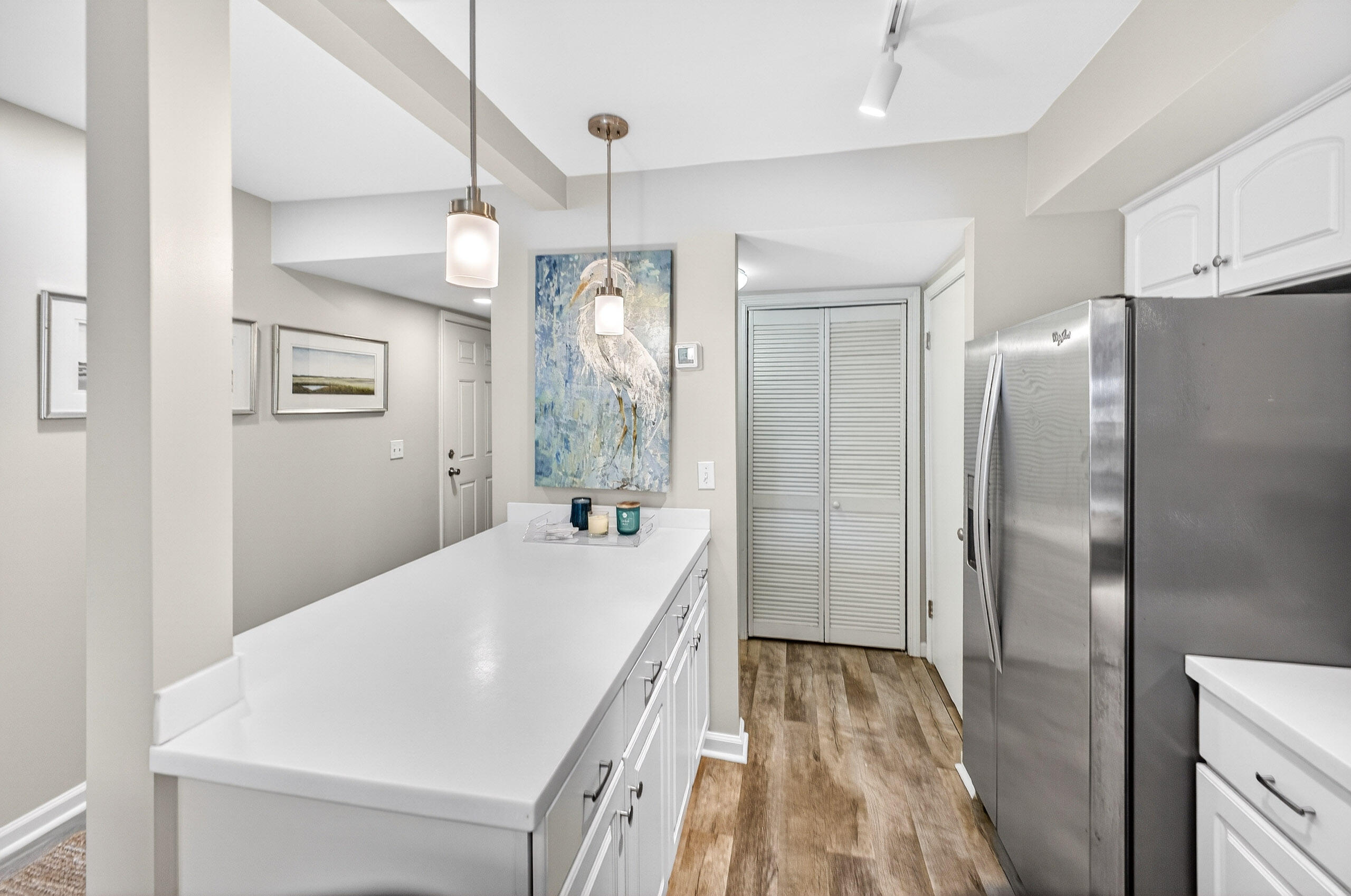 900 Harbour Point Lane, Unit 900 Miramar Beach, FL 32550 - Photo 10 of 64 a kitchen with stainless steel appliances a refrigerator and a chandelier