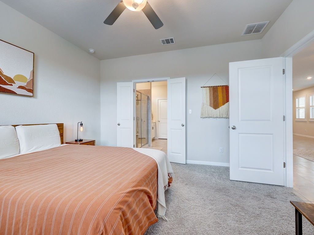 325 Serpens Street Georgetown, TX 78628 - Photo 16 of 40 Ceiling fan and walk in closet in primary suite