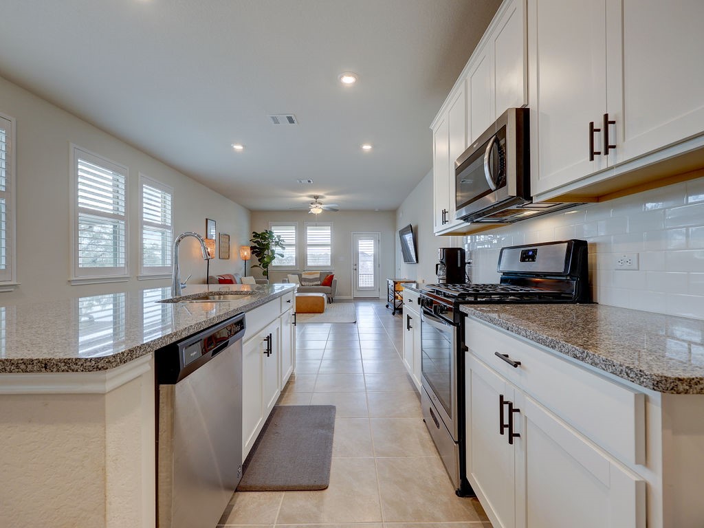 325 Serpens Street Georgetown, TX 78628 - Photo 5 of 40 Modern kitchen with granite counters