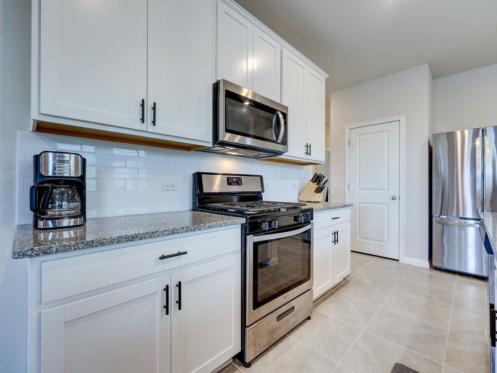 325 Serpens Street Georgetown, TX 78628 - Photo 6 of 40 Stainless appliances and gas cooking