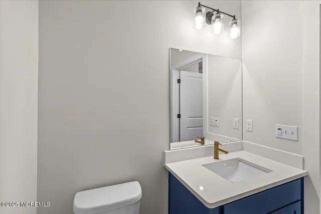 a bathroom with a sink toilet and vanity