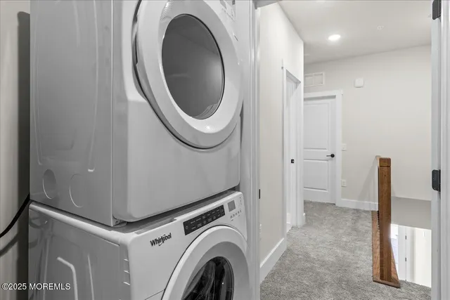 a view of a hallway with washer and dryer